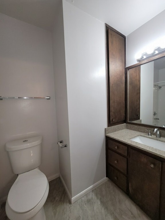 2529 Rio Grande Street, Unit 20 Austin, TX 78705 - Photo 18 of 19 a bathroom with a toilet a sink and mirror
