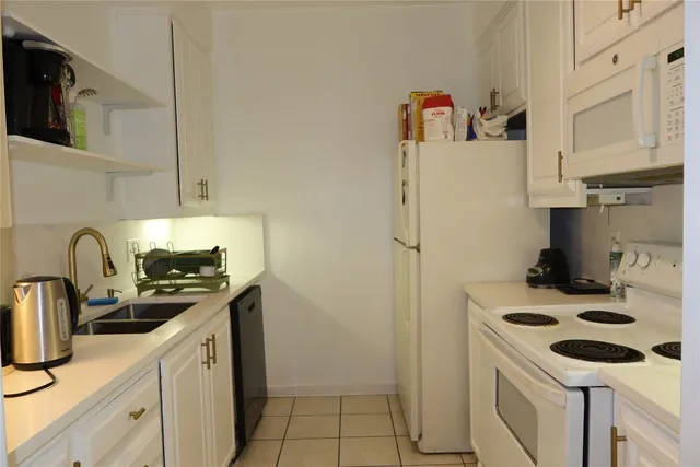 a kitchen with a sink a stove and refrigerator