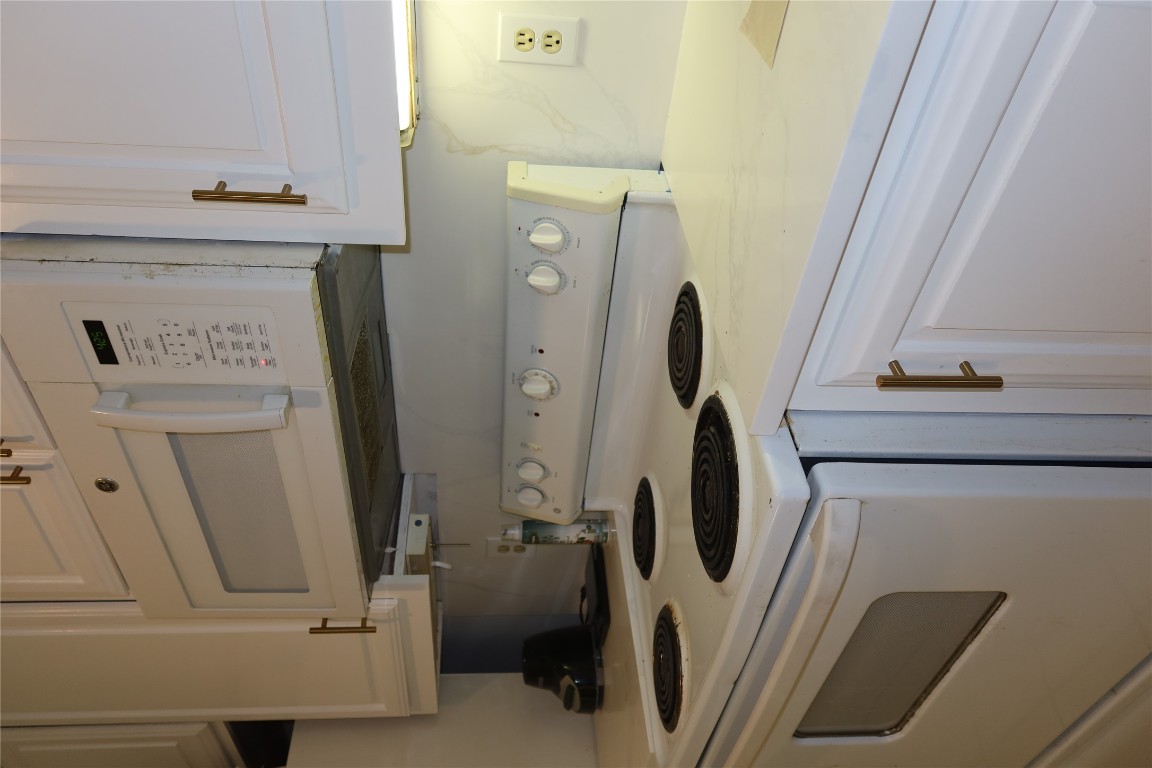 2529 Rio Grande Street, Unit 20 Austin, TX 78705 - Photo 7 of 19 a kitchen with a stove and white cabinets