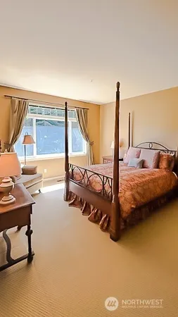 a large bedroom with a bed and a dresser in it