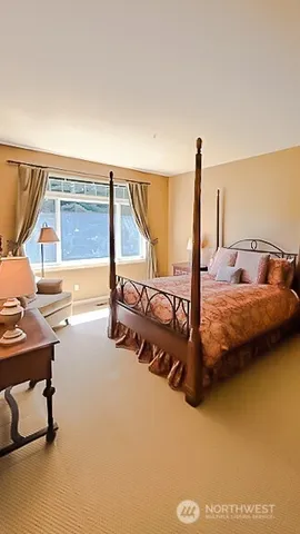 a large bedroom with a bed and a dresser in it