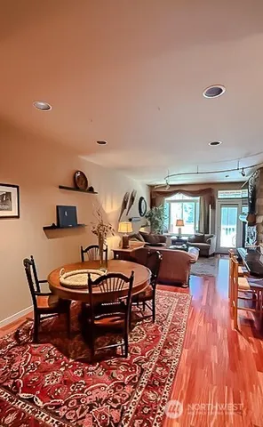 a dining room with furniture and a large window