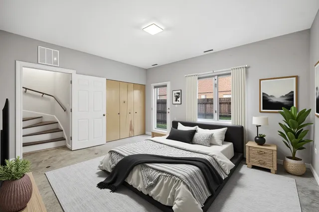 a bedroom with a large bed and a potted plant