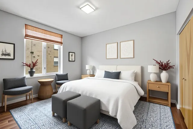 a bedroom with a bed and wooden floor