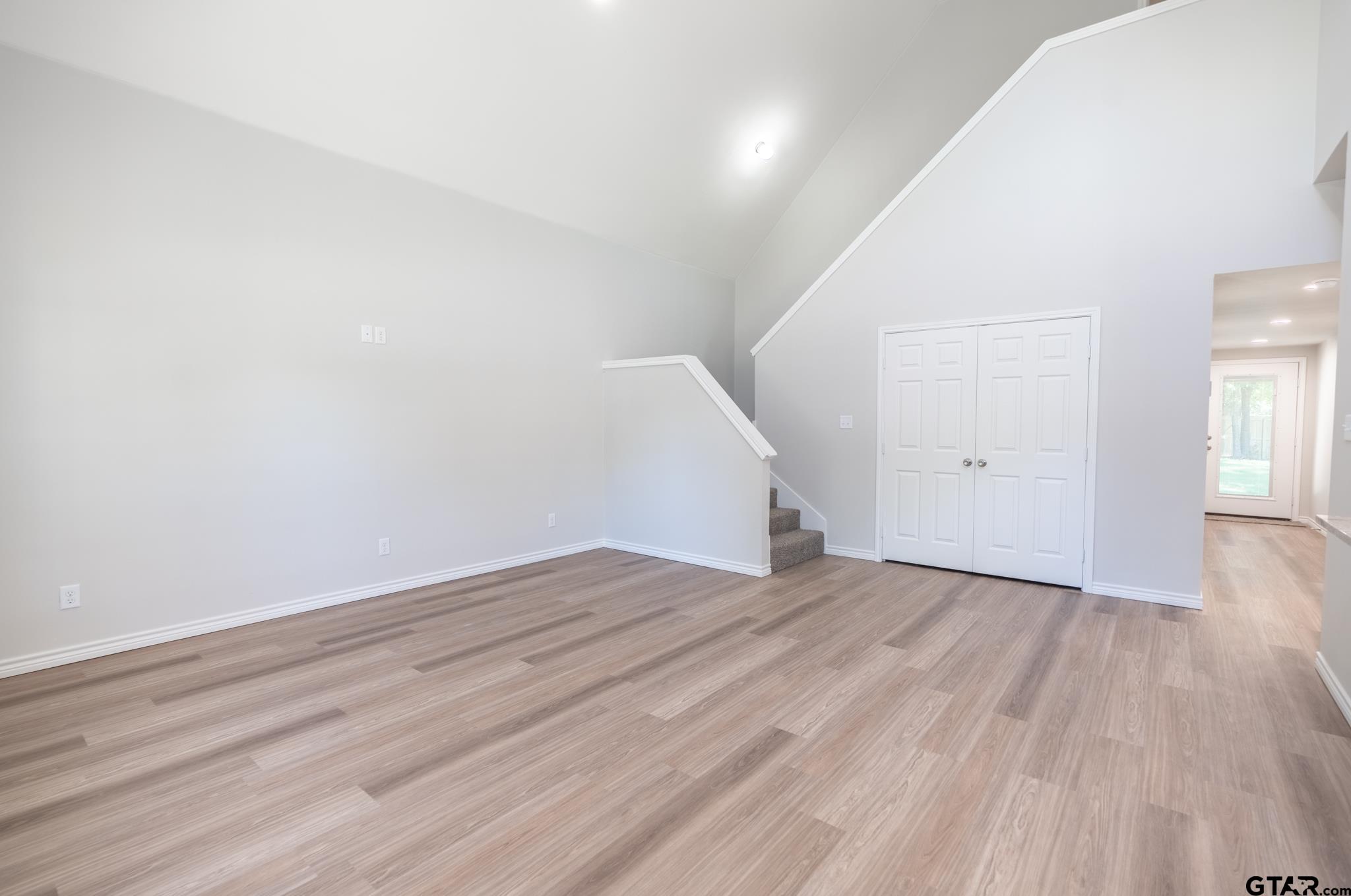233 Harrison Street Longview, TX 75601 - Photo 9 of 44 wooden floor in an empty room with a window