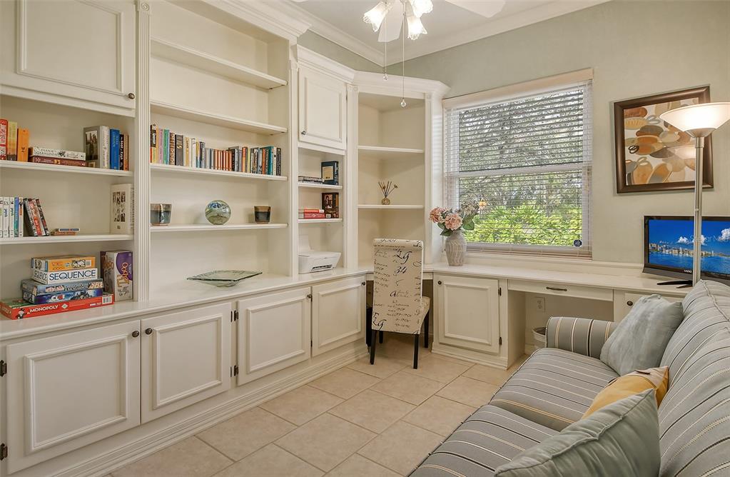 6504 Copper Ridge Trail Bradenton, FL 34201 - Photo 28 of 55 Bedroom 3 with built-ins for storage or to use as office space. Note crown molding and lighting.