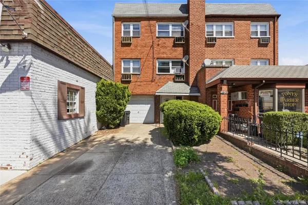 a view of a brick building next to a yard