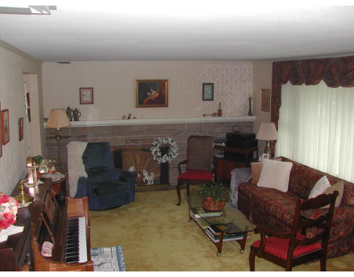 57 Tudor Road Needham, MA 02492 - Photo 2 of 4 a living room with furniture and a fireplace