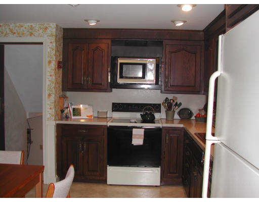 57 Tudor Road Needham, MA 02492 - Photo 3 of 4 a kitchen with stainless steel appliances granite countertop a refrigerator and a stove top oven