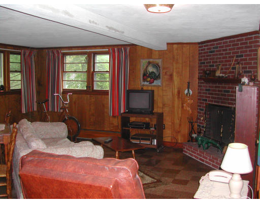 57 Tudor Road Needham, MA 02492 - Photo 4 of 4 a bedroom with a bed dresser and a flat screen tv