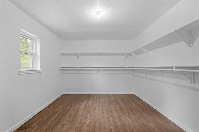 a view of a room with wooden floor and windows