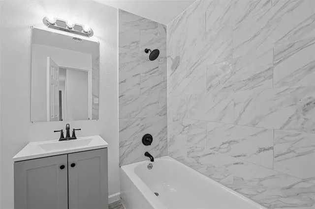 a bathroom with a bathtub and sink