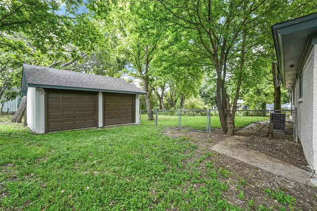 a view of a backyard with large trees
