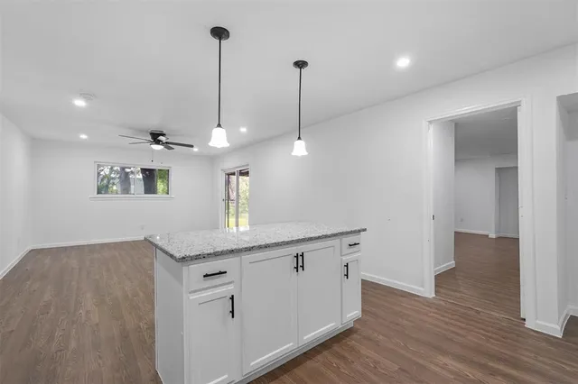 a view of a kitchen with a sink and wooden floor