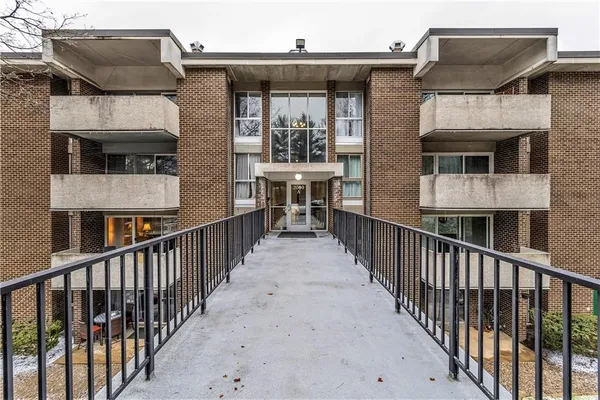 a view of a house with wooden fence