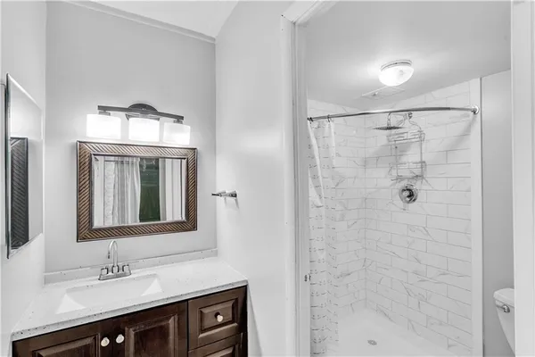 a bathroom with a double vanity sink mirror and bathtub
