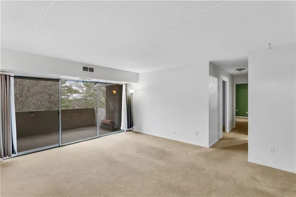 an empty room with sliding glass door