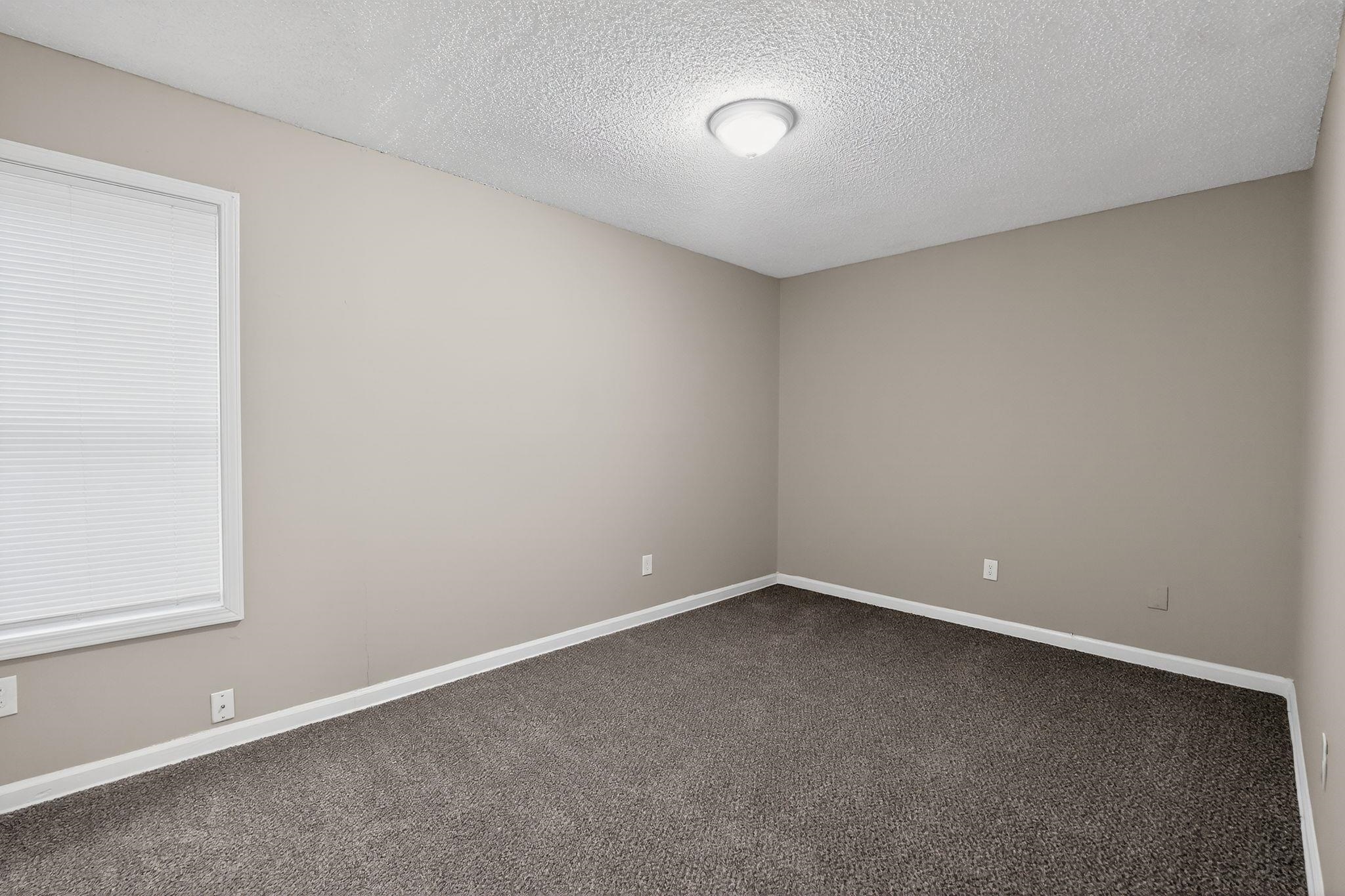 4725 Lofts Road Memphis, TN 38118 - Photo 14 of 32 Unfurnished room with dark colored carpet and a textured ceiling
