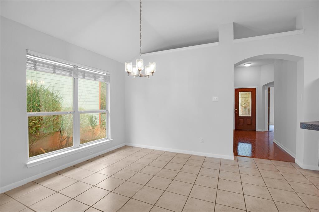 281 Hutton Kyle, TX 78640 - Photo 6 of 37 Natural light floods this dining area, featuring an elegant vaulted ceiling and contemporary lighting.