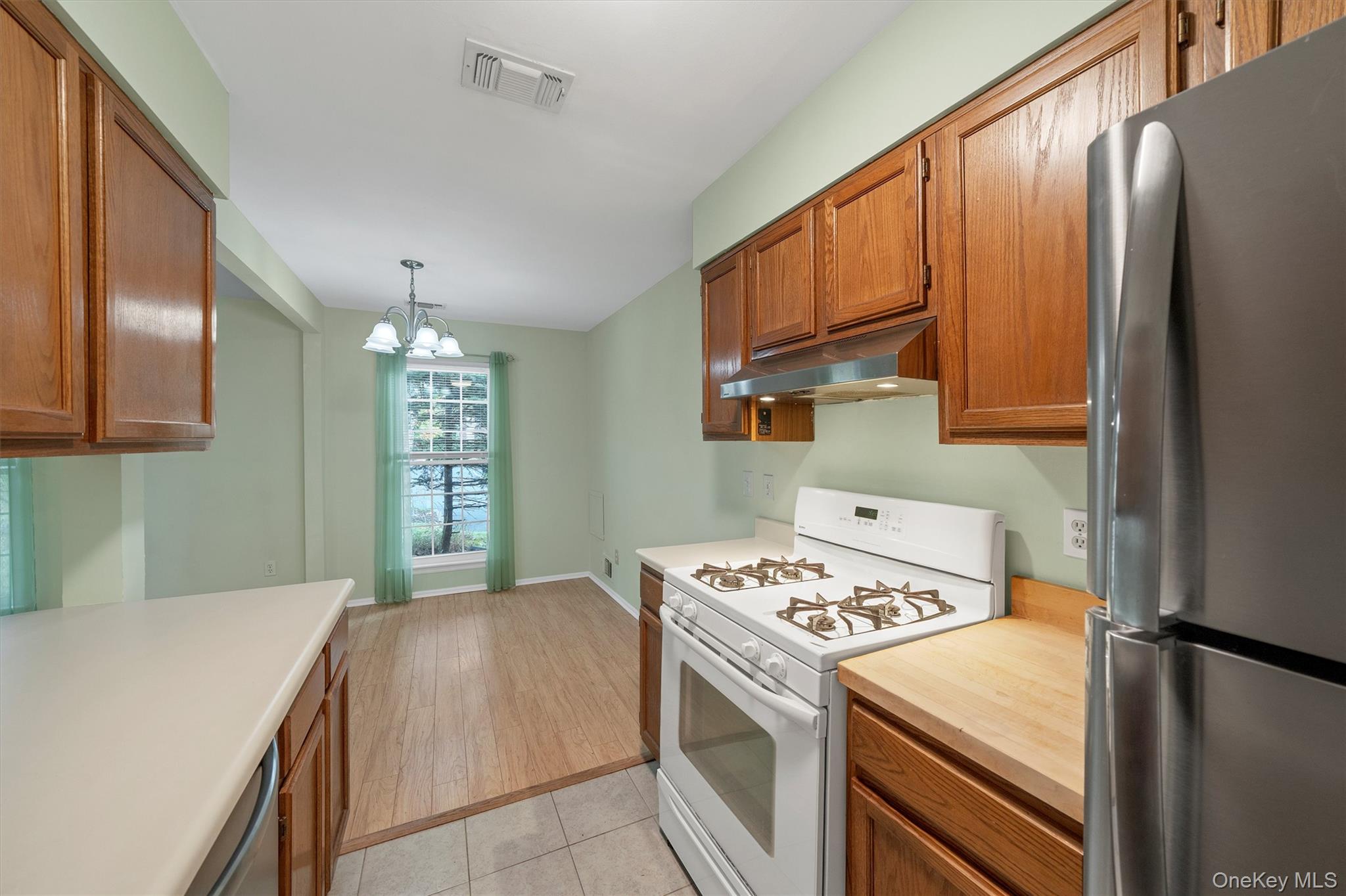 29 The Rise Warwick, NY 10990 - Photo 16 of 28 a kitchen with a stove a sink and a refrigerator