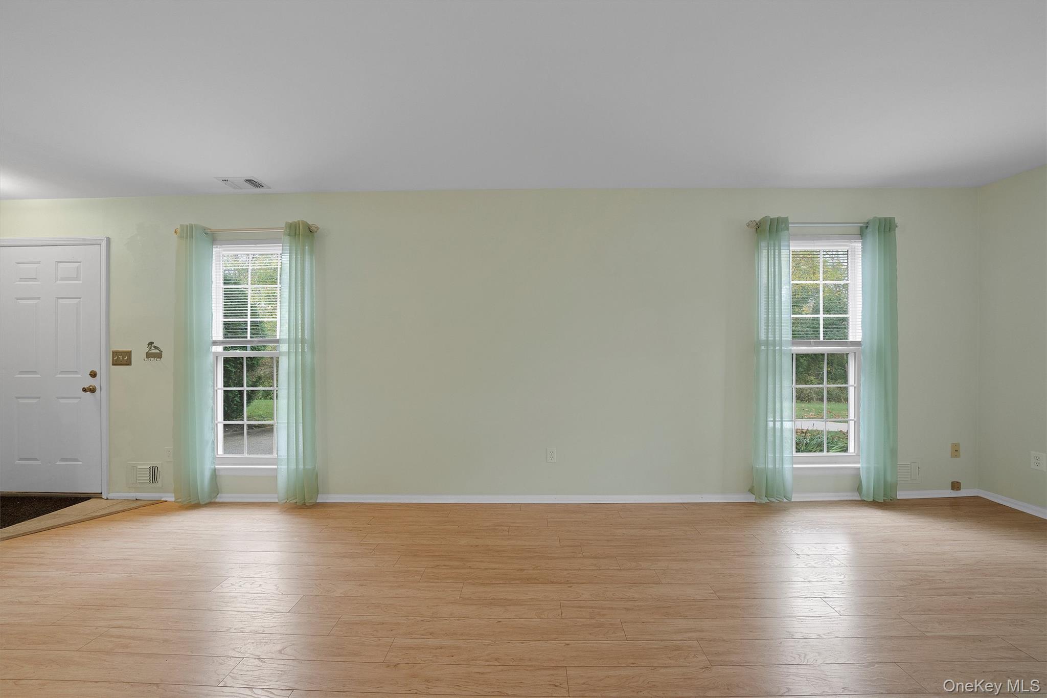 29 The Rise Warwick, NY 10990 - Photo 8 of 28 an empty room with wooden floor and windows