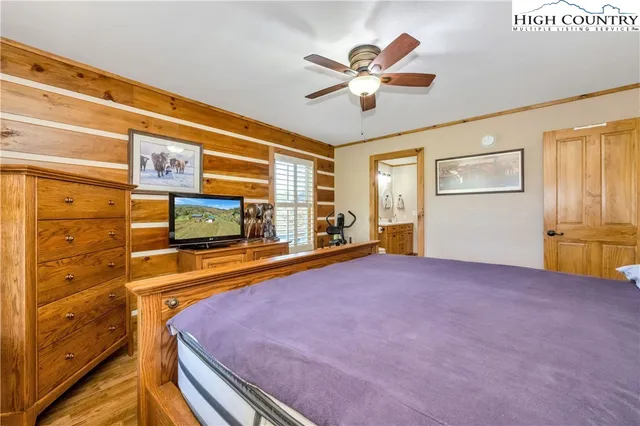 a blue bed sitting in a bedroom next to a window