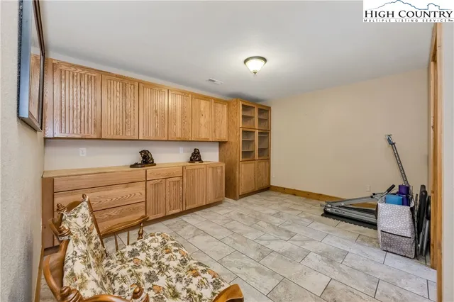 a view of a balcony with furniture and wooden floor