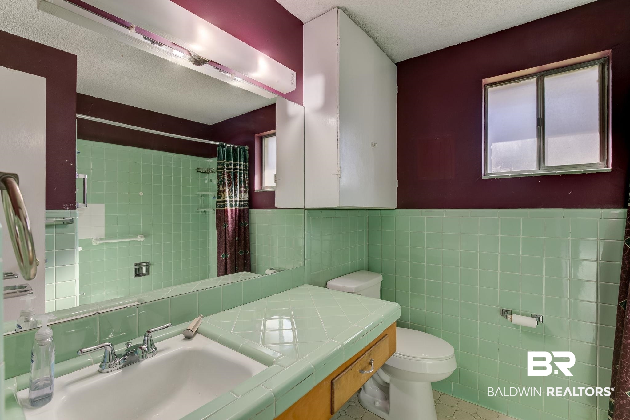 606 East Myrtle Avenue Foley, AL 36535 - Photo 9 of 24 Bathroom featuring a textured ceiling, toilet, sink, and tile walls