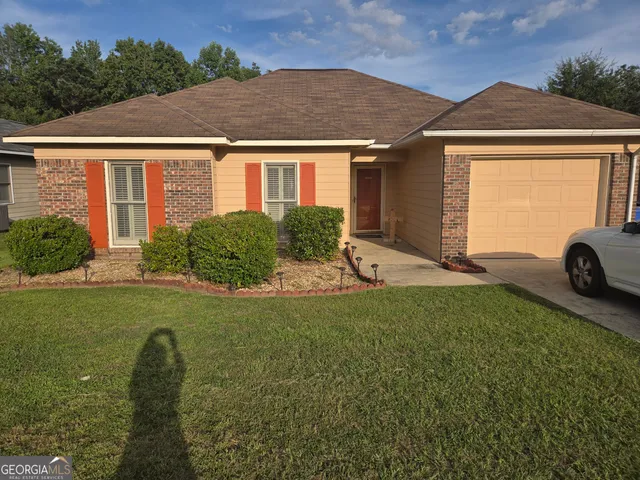 a front view of a house with a yard