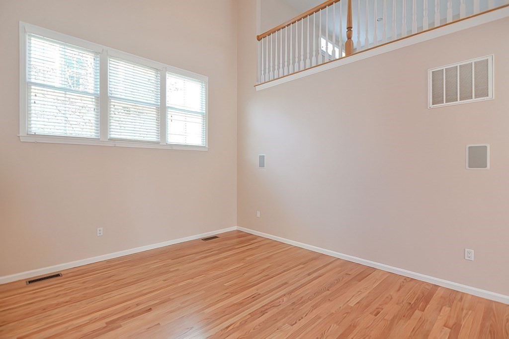 30 Codding Road, Unit 30 Norton, MA 02766 - Photo 13 of 40 an empty room with wooden floor and windows