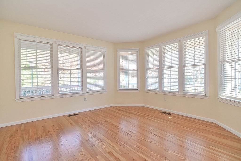 30 Codding Road, Unit 30 Norton, MA 02766 - Photo 19 of 40 a view of an empty room with wooden floor and a window
