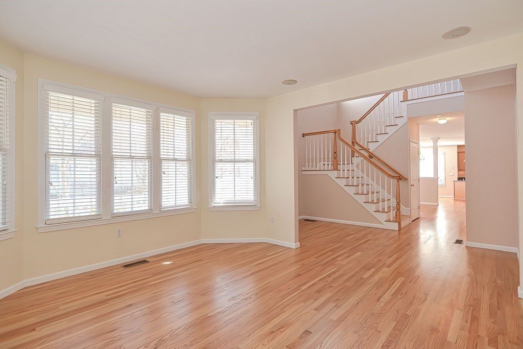 30 Codding Road, Unit 30 Norton, MA 02766 - Photo 20 of 40 a view of an empty room with wooden floor and a window