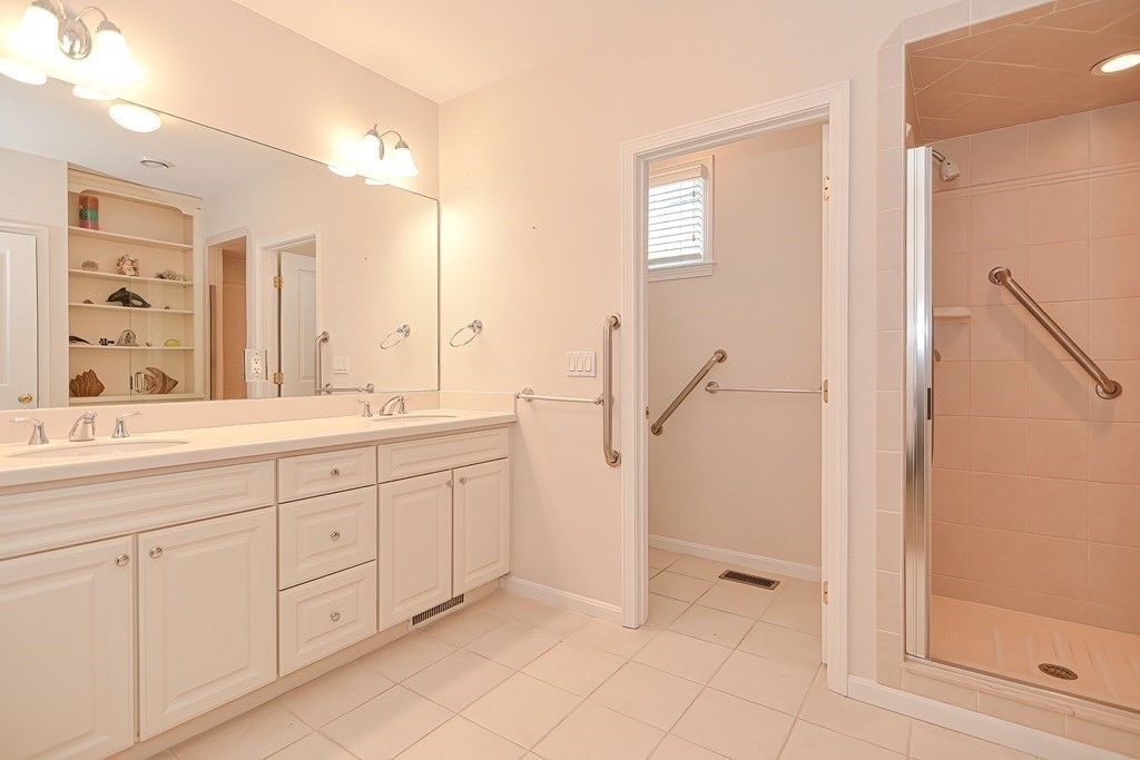 30 Codding Road, Unit 30 Norton, MA 02766 - Photo 23 of 40 a spacious bathroom with a shower a sink and a mirror