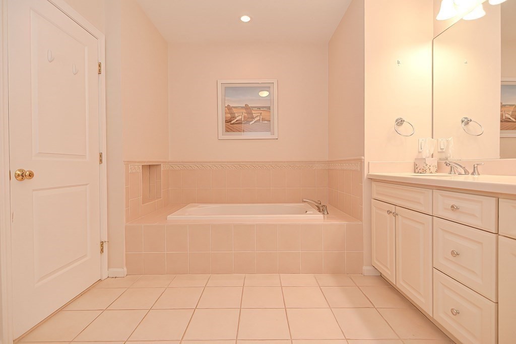 30 Codding Road, Unit 30 Norton, MA 02766 - Photo 24 of 40 a spacious bathroom with a bathtub and a sink
