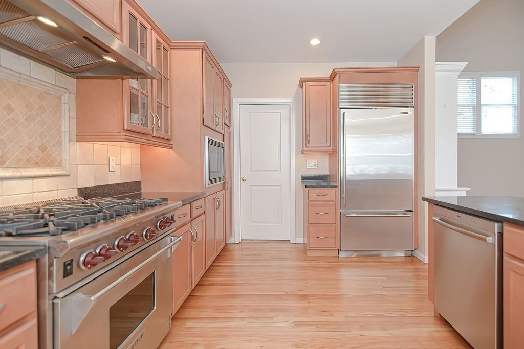 30 Codding Road, Unit 30 Norton, MA 02766 - Photo 5 of 40 a kitchen with stainless steel appliances granite countertop a stove and a refrigerator