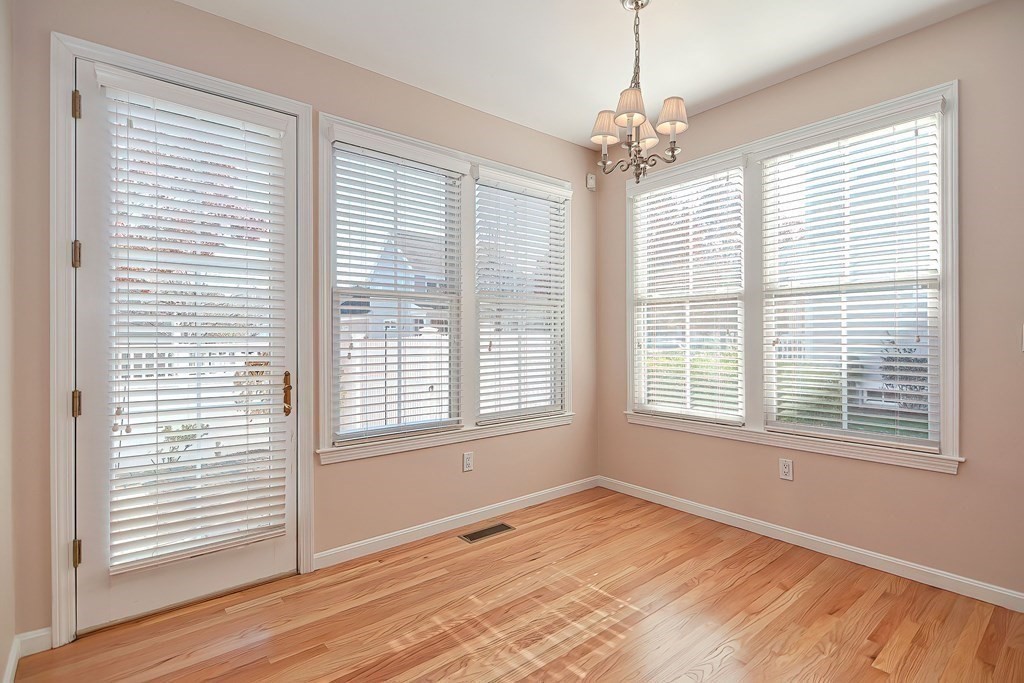 30 Codding Road, Unit 30 Norton, MA 02766 - Photo 8 of 40 a view of an empty room with wooden floor and a window