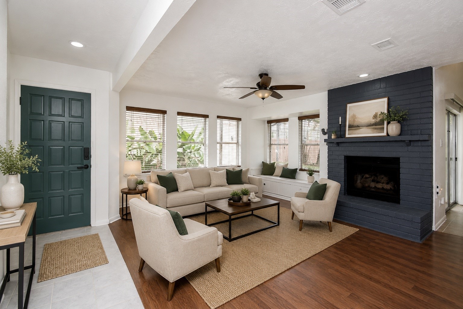 8715 Vinkins Road Houston, TX 77071 - Photo 10 of 48 The spacious family room welcomes you with abundant natural light, warm wood-look flooring, and a cozy painted brick fireplace. Large windows frame the outdoor living area, creating a bright and inviting space perfect for everyday living and entertaining. Virtually staged.