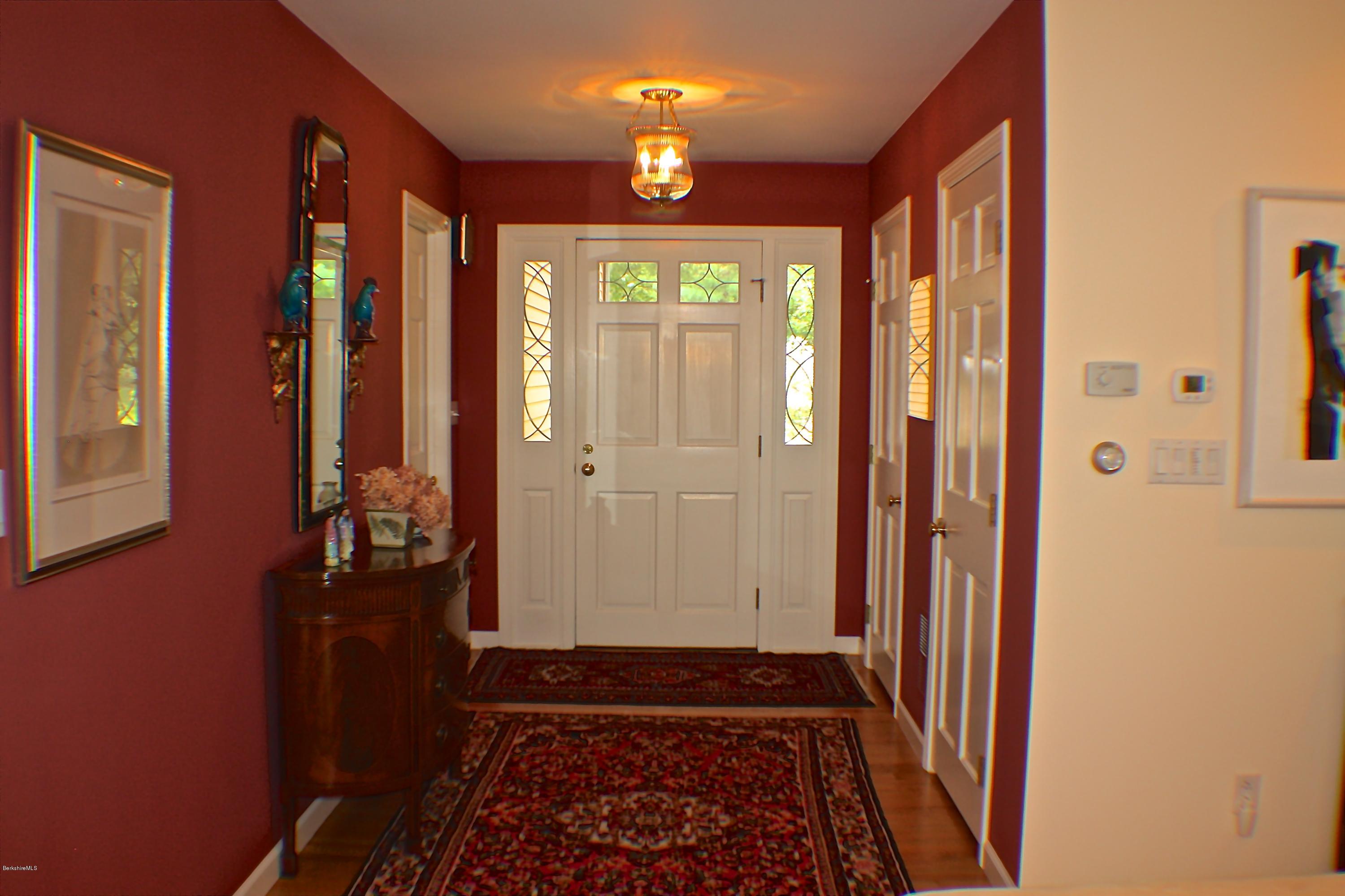 11 Quiet Knoll Road Stockbridge, MA 01266 - Photo 5 of 23 a view of a hallway with wooden floor and a livingroom