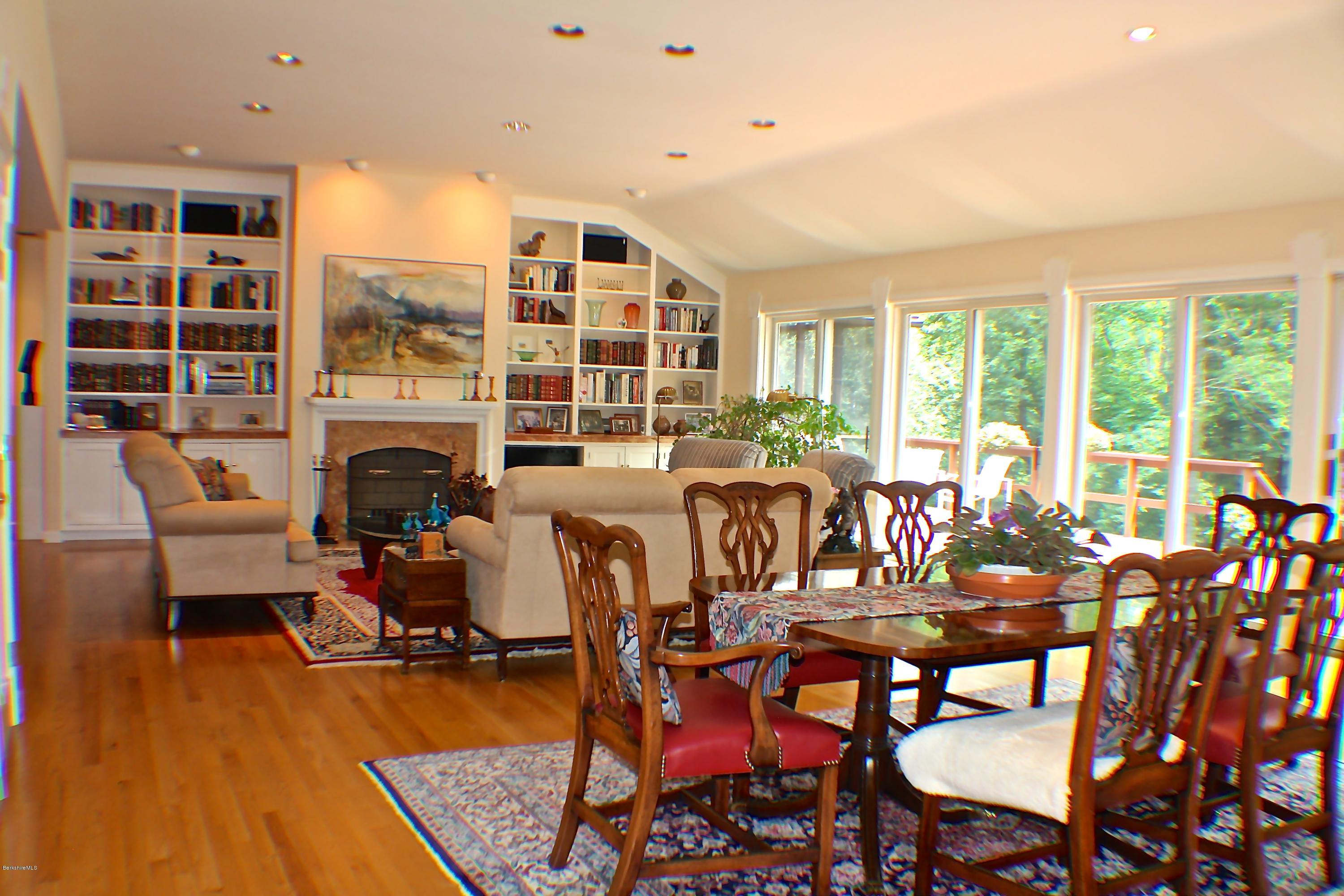 11 Quiet Knoll Road Stockbridge, MA 01266 - Photo 6 of 23 a living room with furniture a fireplace and a floor to ceiling window
