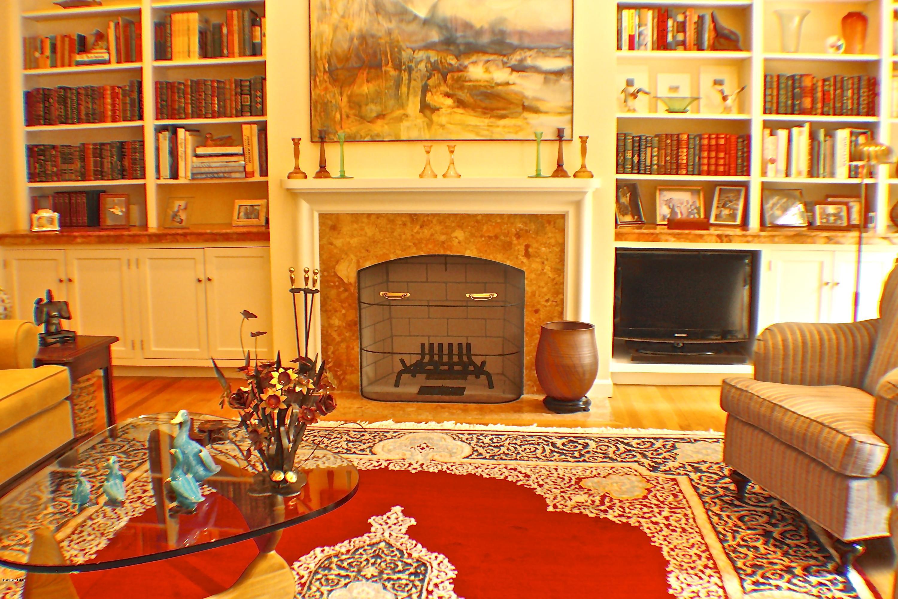 11 Quiet Knoll Road Stockbridge, MA 01266 - Photo 8 of 23 a living room with furniture a fireplace and a flat screen tv