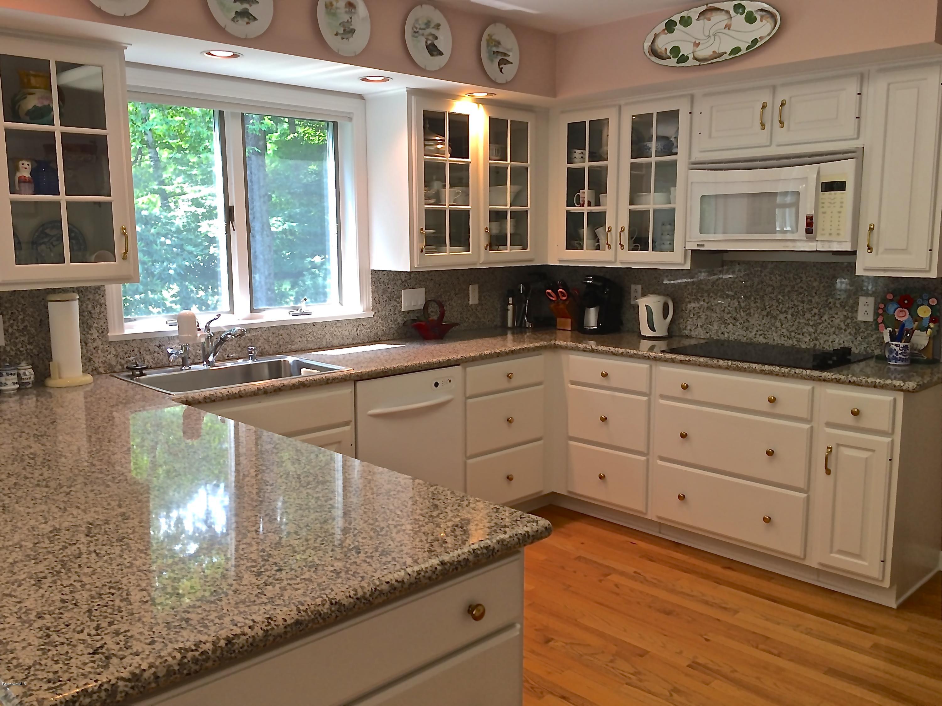 11 Quiet Knoll Road Stockbridge, MA 01266 - Photo 10 of 23 a kitchen with stainless steel appliances granite countertop a sink and cabinets with wooden floor