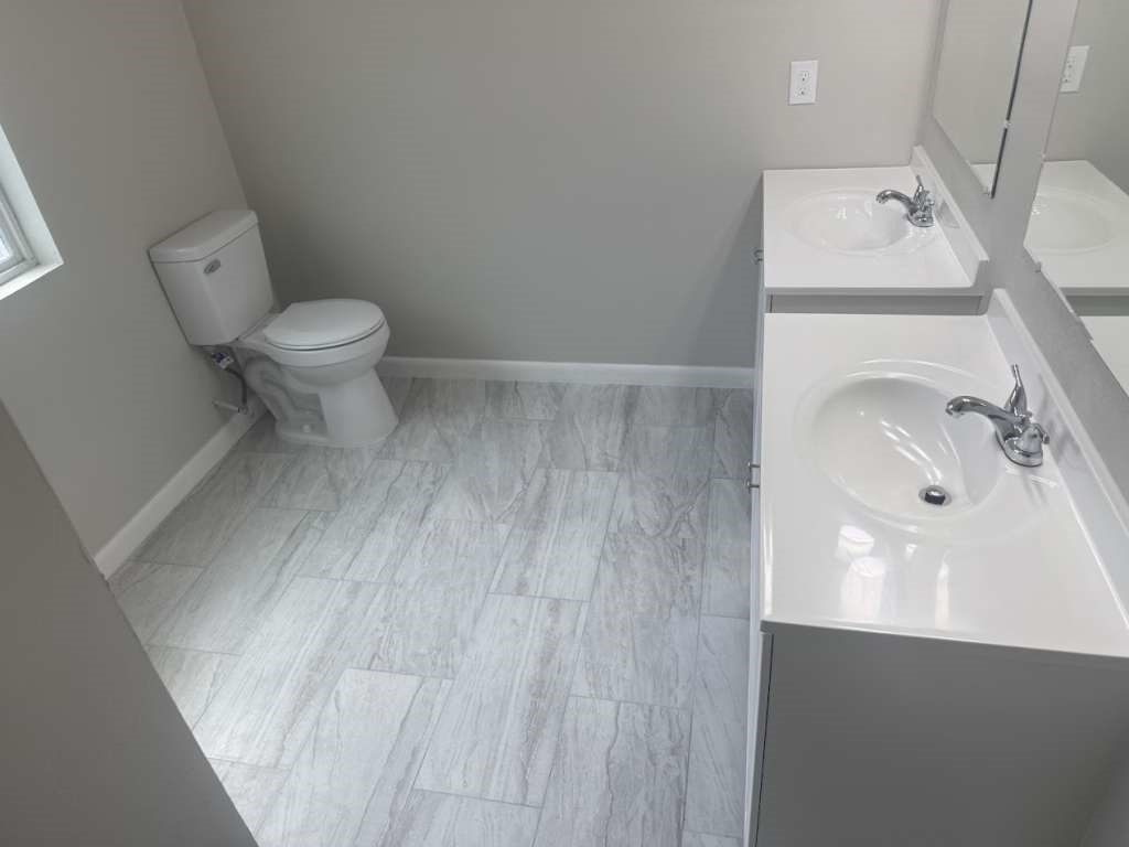 14911 Walters Road Houston, TX 77068 - Photo 12 of 13 a bathroom with a sink and a toilet