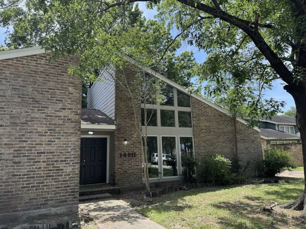 14911 Walters Road Houston, TX 77068 - Photo 2 of 13 a front view of a house with garden