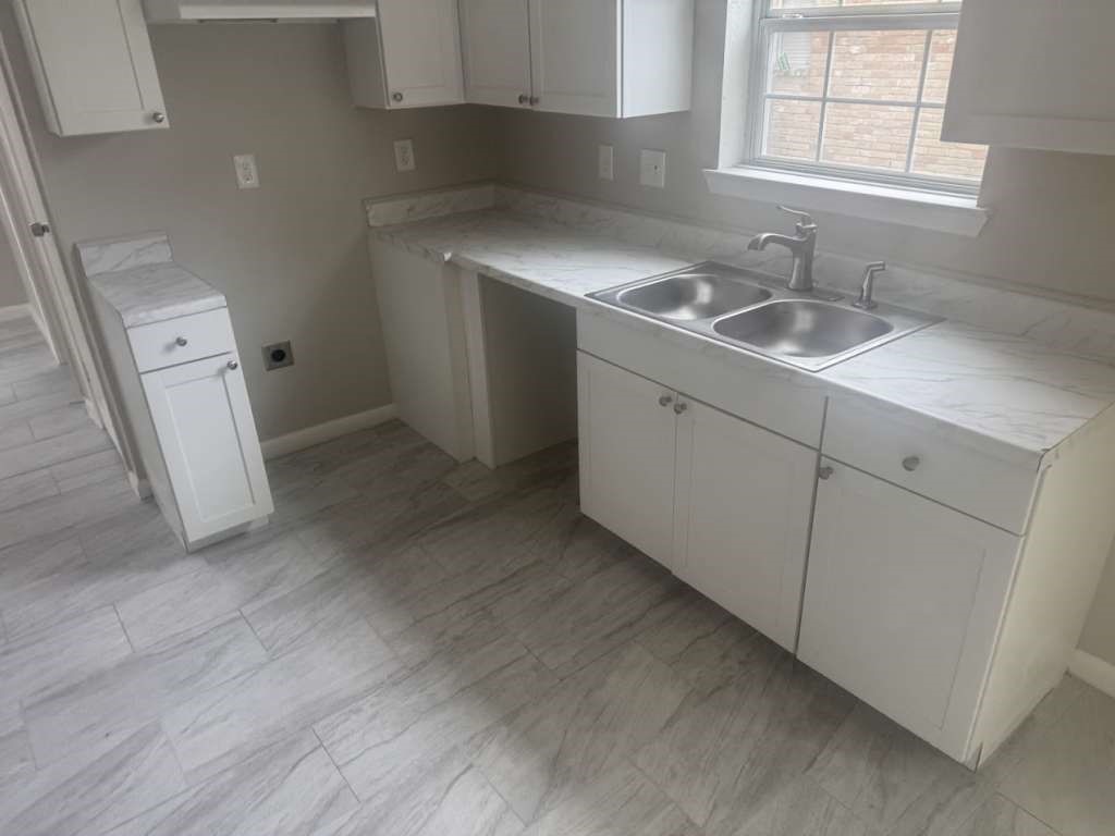 14911 Walters Road Houston, TX 77068 - Photo 5 of 13 a kitchen with a sink and cabinets