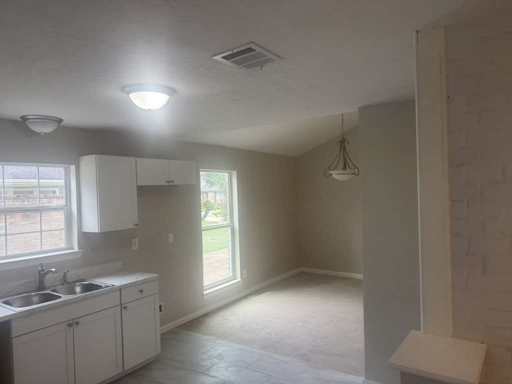 14911 Walters Road Houston, TX 77068 - Photo 6 of 13 a view of a kitchen with two windows and a sink
