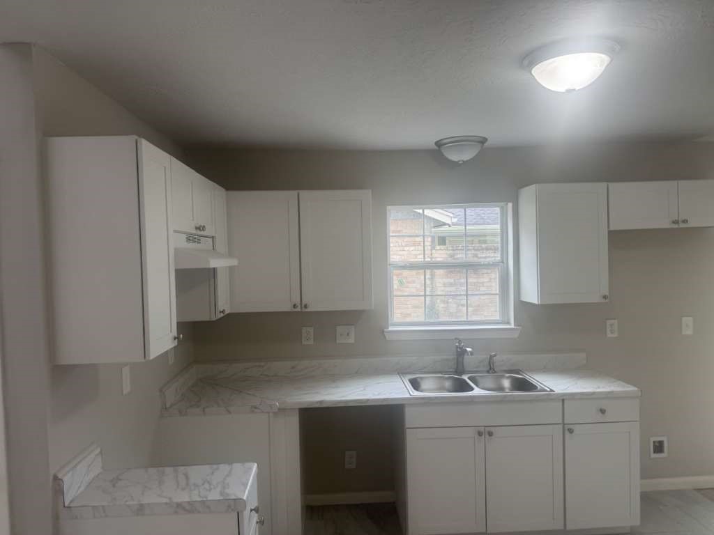 14911 Walters Road Houston, TX 77068 - Photo 8 of 13 a kitchen with stainless steel appliances granite countertop a sink and dishwasher a refrigerator with wooden cabinets