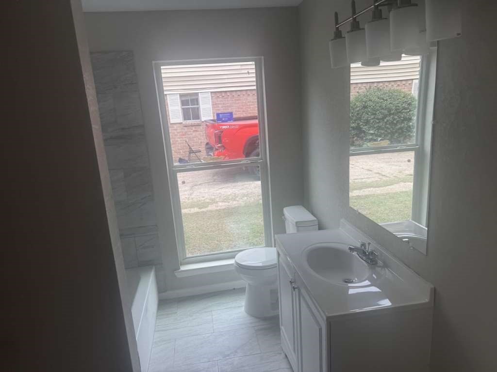 14911 Walters Road Houston, TX 77068 - Photo 9 of 13 a bathroom with a sink toilet and next to a window