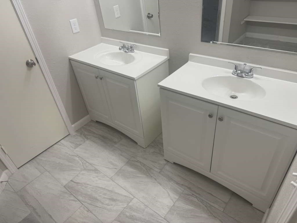 14911 Walters Road Houston, TX 77068 - Photo 10 of 13 a bathroom with 2 sink and a mirror