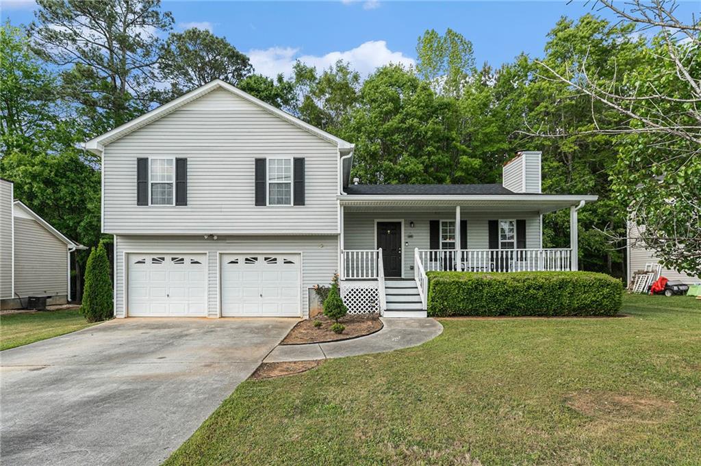 329 River Trace Drive Villa Rica, GA 30180 - Photo 1 of 1 a front view of a house with a yard and garage