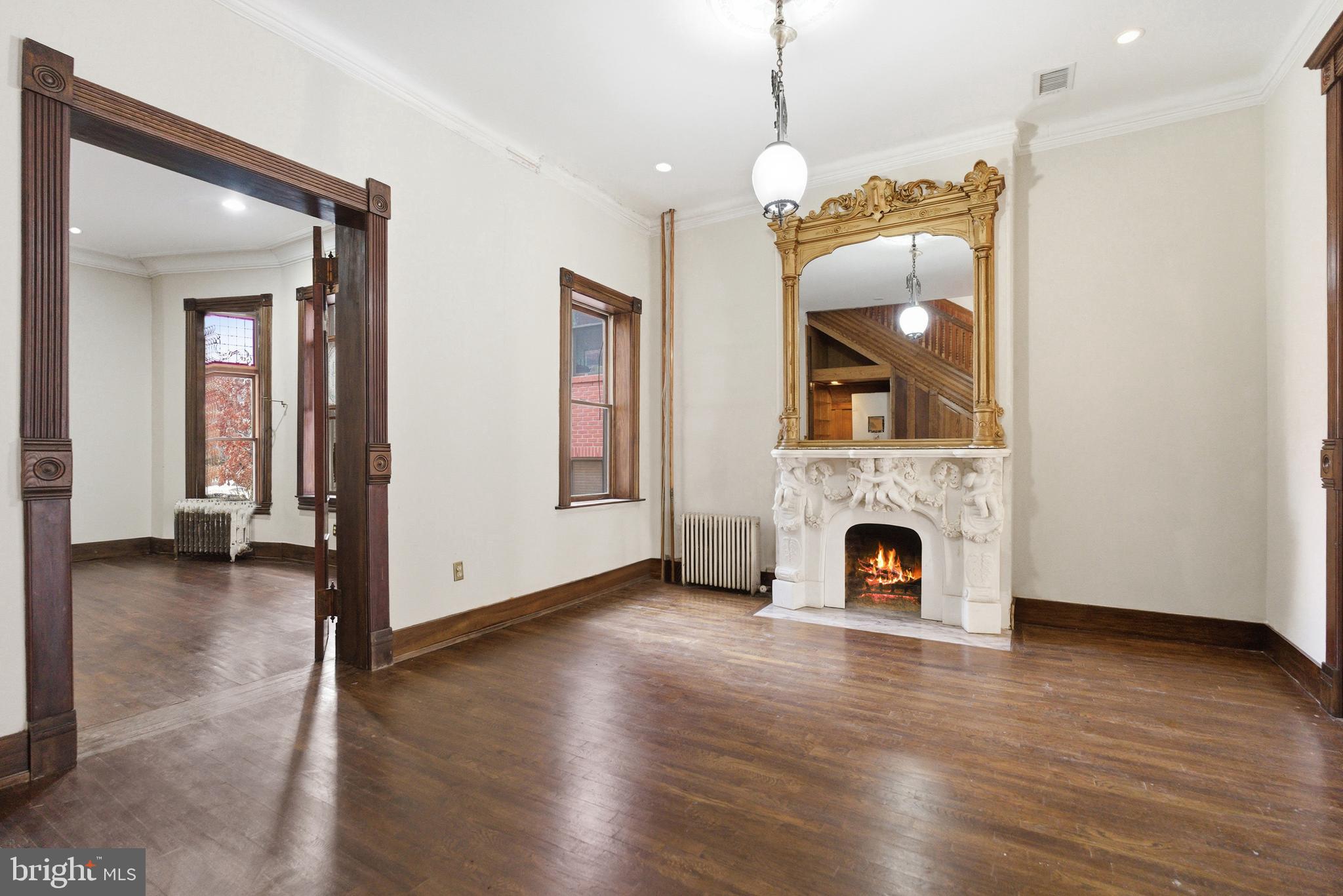 1827 13th Street Northwest Washington, DC 20009 - Photo 6 of 15 an entryway and a livingroom with a fireplace